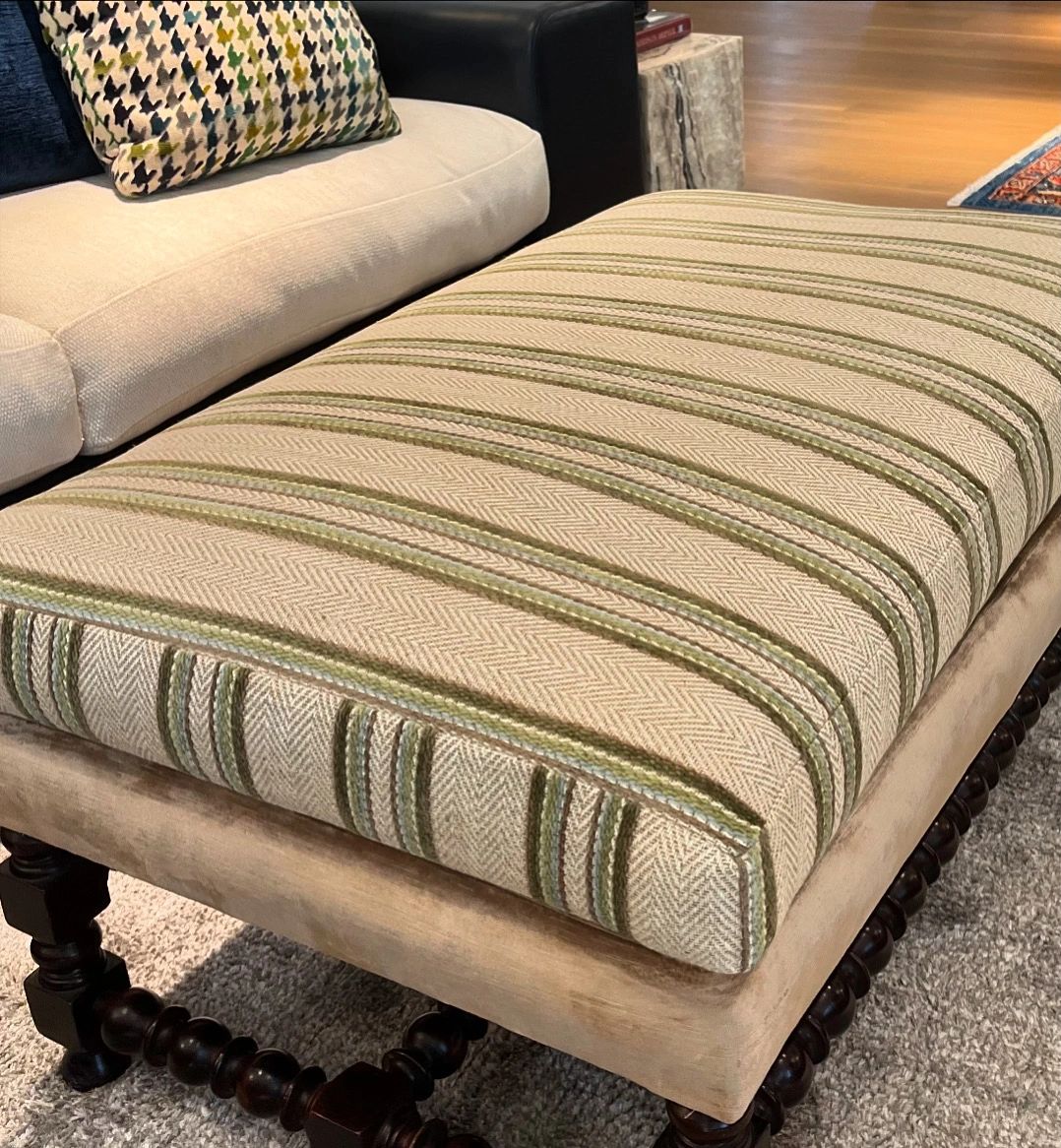 Reupholstered ottoman with striped fabric