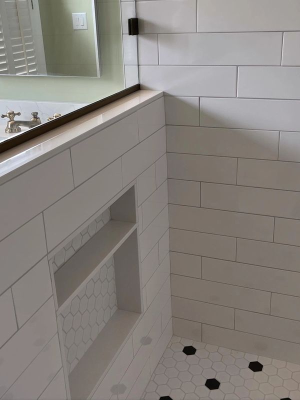 Subway tile in shower with niche