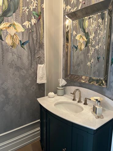 Powder room with wallpaper and large mirror