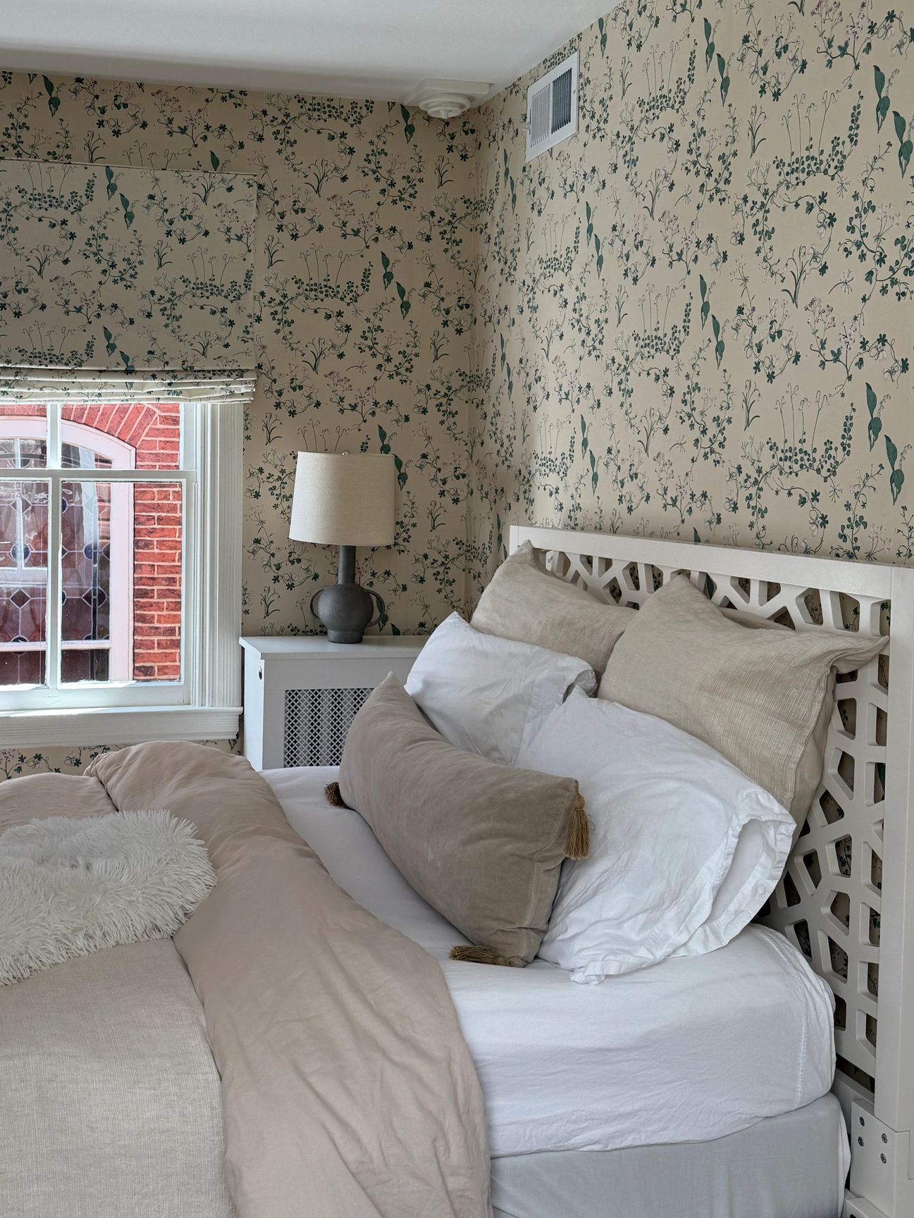 Bedroom with wallpaper and matching roman shade