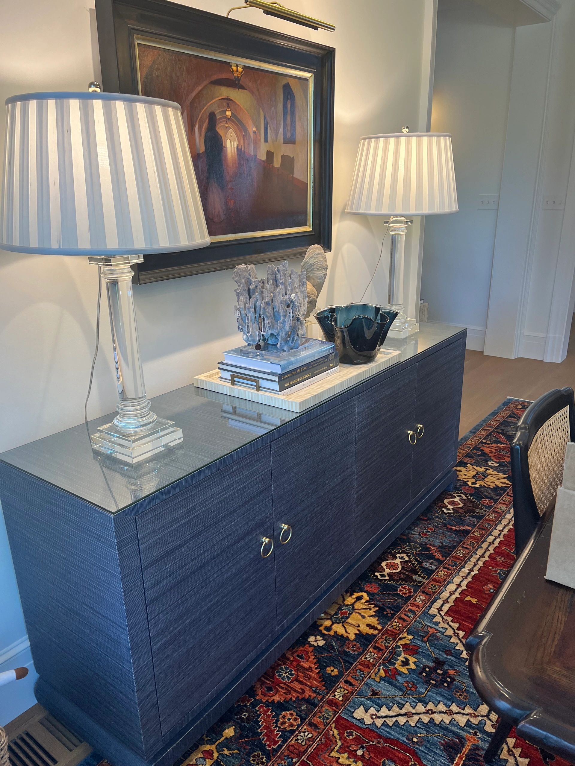 Side buffet in grasscloth with crystal lamps