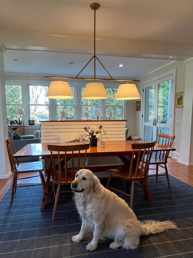 Dining space with blue rug and windsor chairs