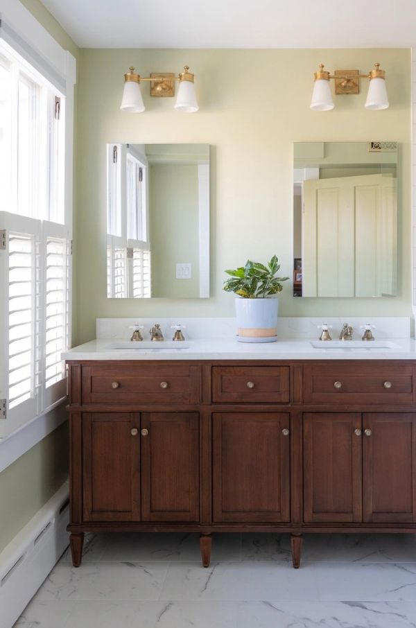 Double wooden vanity with medicine cabinets and sconces