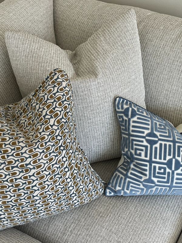 Pillows on the sectional add texture and color in blue