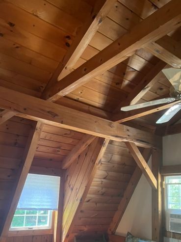 Post and beams run across the pitched ceiling make lighting a challenge