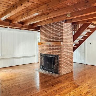 Open plan post and beam with fireplace in the middle of the space