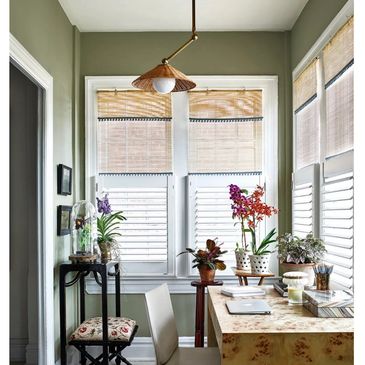 Office with rattan shades and pendant light burl wood desk