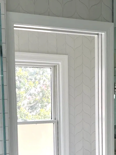 Wallpaper in the toilet room mimics tiled walls at a fraction of the price