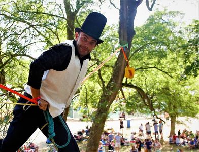 a highliner getting ready for a highline performance at a music festival