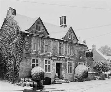 An exterior photograph of the pub in Nympsfield in the snow