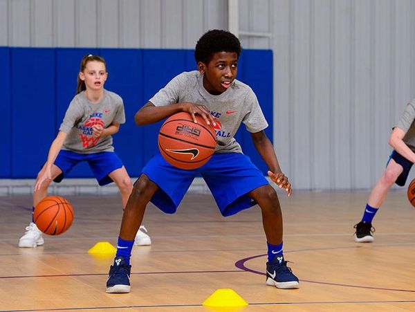 kids learning basketball skills at ymca gym