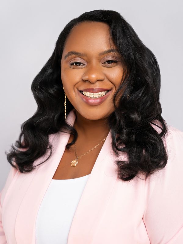 A Headshot Image Of A Woman With A Smile