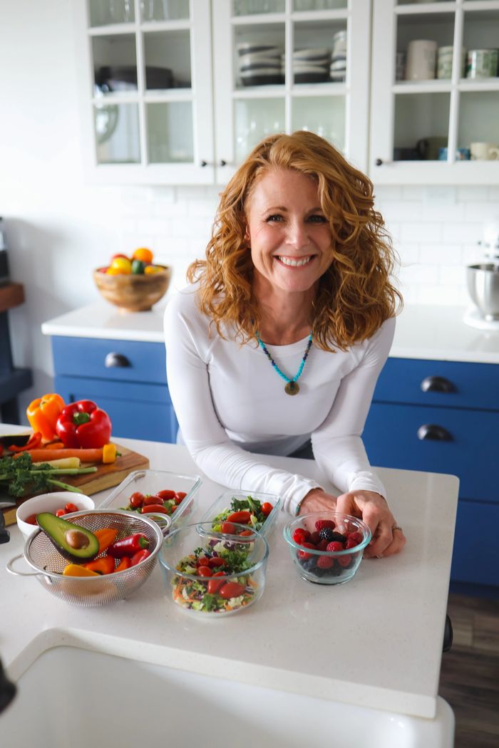 Siouxsie with red hair in the kitchen with healthy foods