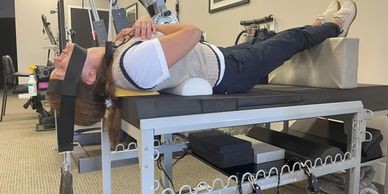 Person undergoing spinal traction therapy in a clinic. Chronic headaches, migraine relief, omaha headache clinic