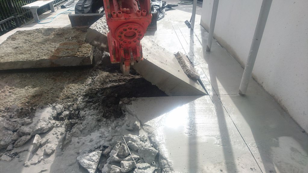 Rock breaker removes section of slab in a state school at the main gate entrance.
