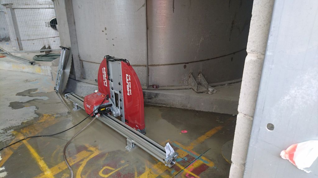 Track saw getting in close to permanent tank structure to facilitate removal of slab.