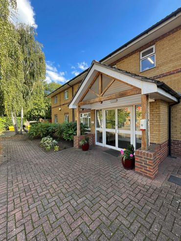 Building entrance with planters and shrubs on the side