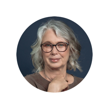 Portrait of a mature woman with glasses and gray hair.