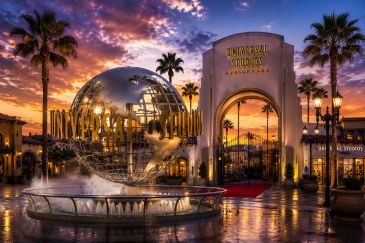 Sunset view of Universal Studios Hollywood entrance with iconic globe sculpture.
