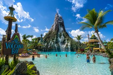 Volcano Bay water park with a volcanic mountain and clear blue sky.