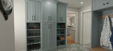 Organized mudroom with gray cabinets and shoe shelves.