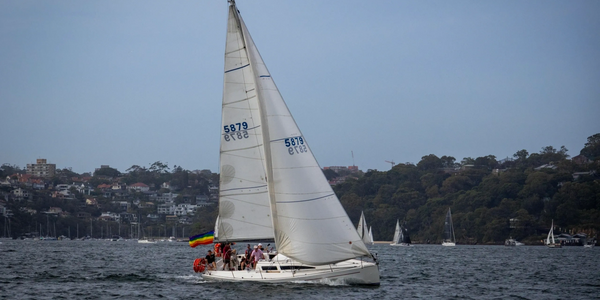 Flying the rainbow flag racing on Sydney Harbour Sydney Pride Regatta