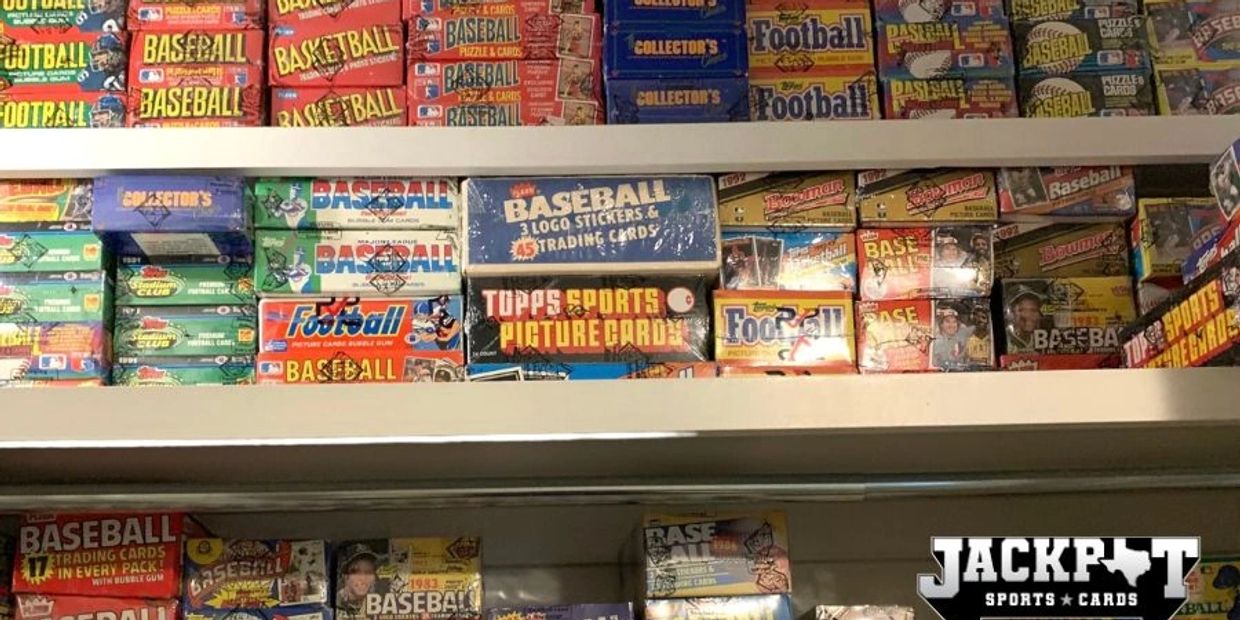 Vintage sports trading card boxes stacked on shelves.