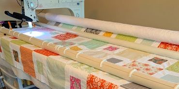 APQS Millie doing longarm quilting on a box step quilt
