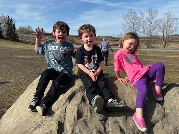 3 grandkids on a rock