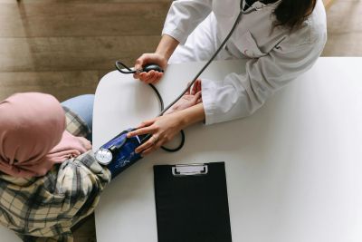 Doctor measuring patient's blood pressure.