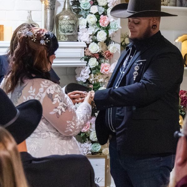 Couple exchanging rings during a wedding ceremony.