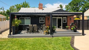 Modern backyard patio with pergola and outdoor dining area.