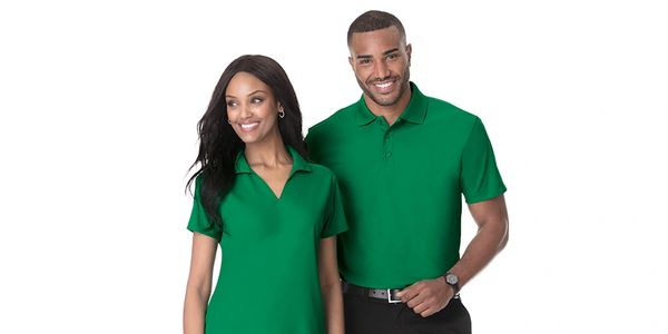 A man and a woman wearing green collared shirts