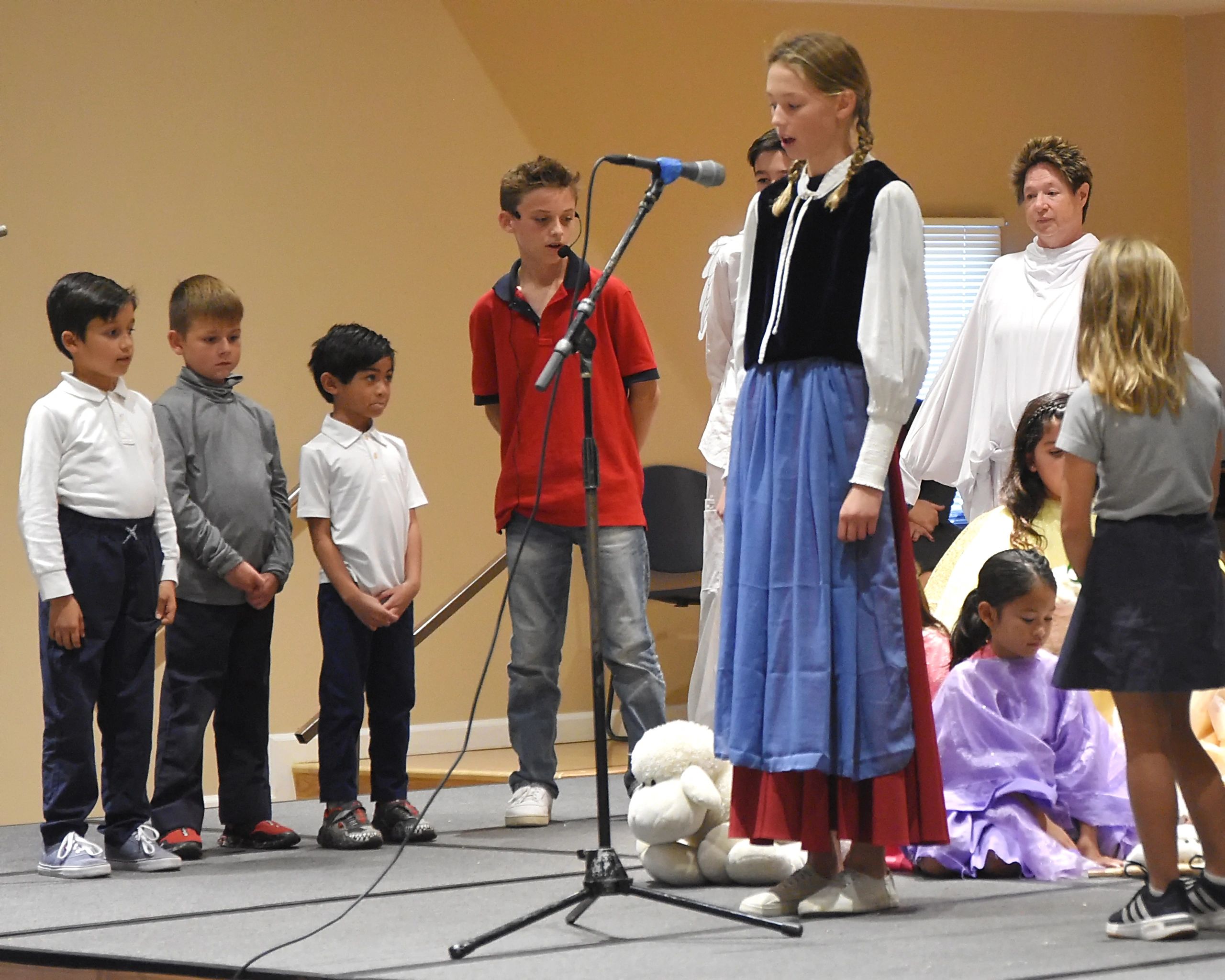 Carlo looks on as St. Germaine tells her Eucharistic Miracle story of how God parted the raging torr