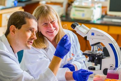 For-Robin President and Founder Kate Rittenhouse-Olson (right) with company senior scientist.