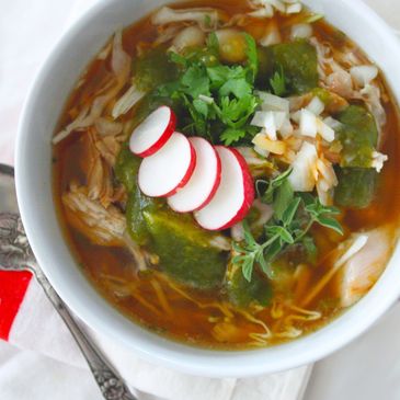 bowl of pozole Mexican chicken soup with cilantro and radish