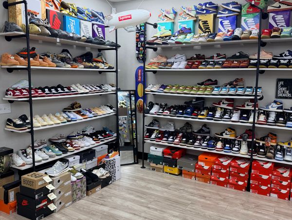 Inside view of a sneaker store with stacked shelves