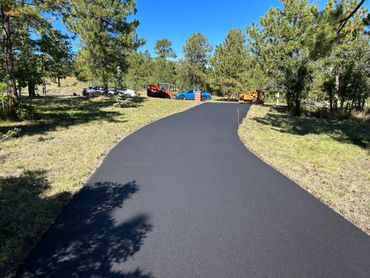 An asphalt road leading to a parking area