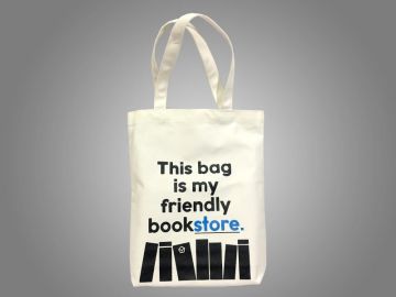 A white tote bag with the phrase 'This bag is my friendly bookstore.' and book graphics.