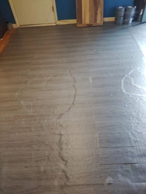 Floor with water damage and stains.