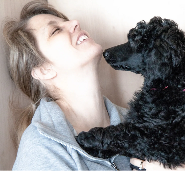 Dog walker snuggling a dog