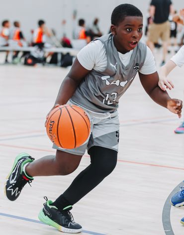 Young basketball player dribbling during a game.