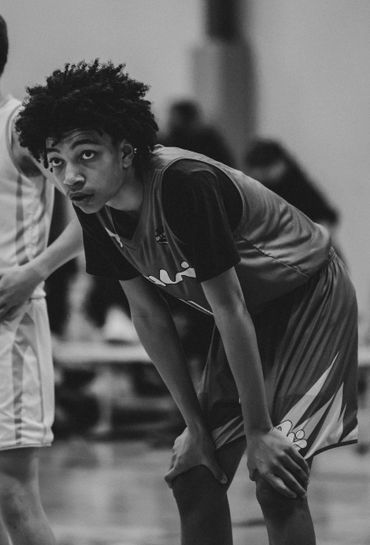 Young basketball player catching breath during a game.
