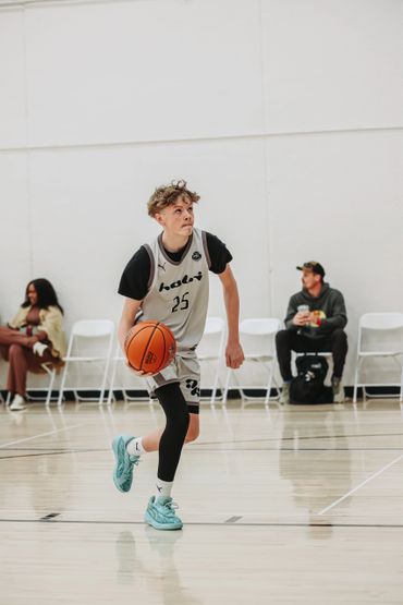 Young basketball player dribbling on the court during a game.