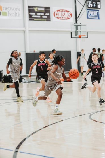 Young players compete intensely in a youth basketball game.