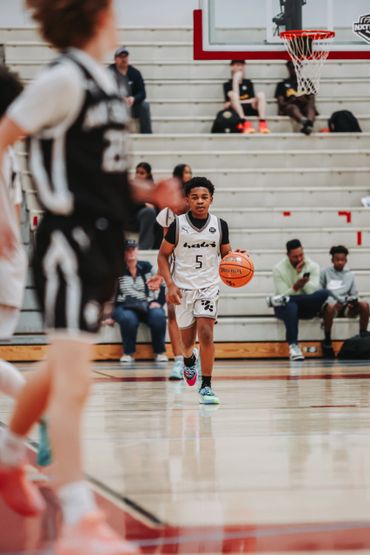 Young basketball player dribbling the ball during a game.