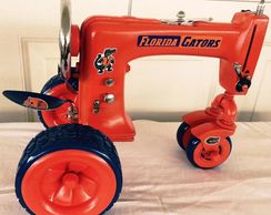 alt=" Orange sewing machine tractor Higley welding"