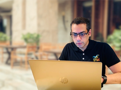 Vikas Dua blogging on a laptop