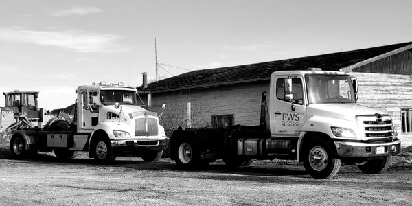 Two FWS trucks parked in line.