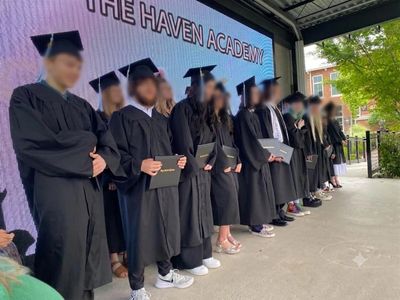The Haven Academy high school graduates in caps and gowns at commencement